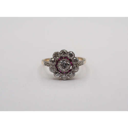 186 - A Diamond and Ruby flower Cluster Ring millegran-set old-cut diamond within frame of small rose-cut ... 