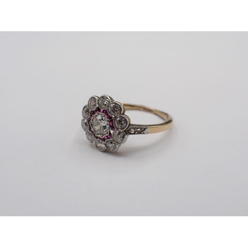 186 - A Diamond and Ruby flower Cluster Ring millegran-set old-cut diamond within frame of small rose-cut ... 