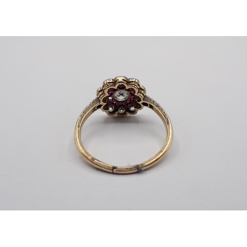 186 - A Diamond and Ruby flower Cluster Ring millegran-set old-cut diamond within frame of small rose-cut ... 