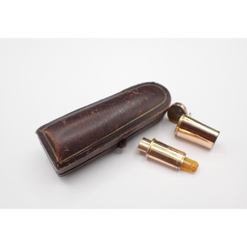 203 - A bakelite Cigar Holder with 9ct gold mount, cased and a telescopic Cigarette Holder in yellow metal... 