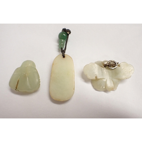 212 - A jade type Netsuke of a seated Buddha and two Pendants