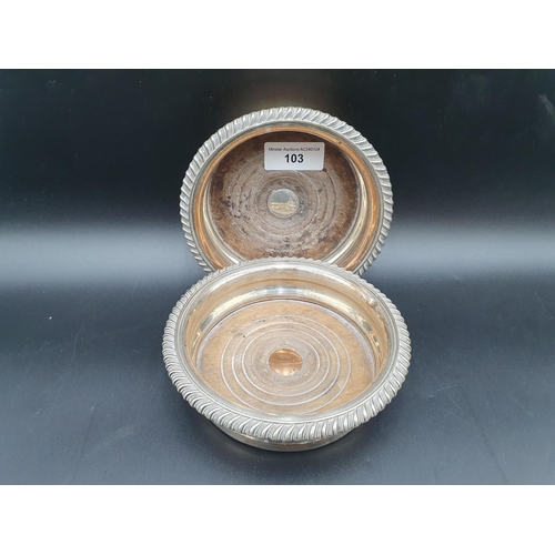 103 - A pair of Sheffield plated circular Coasters with gadroon rims and turned wooden bases, 6in diam