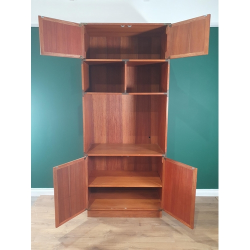 11 - A teak Display Unit/Bookcase with pair of cupboard doors, above open shelves, with pair cupboard doo... 