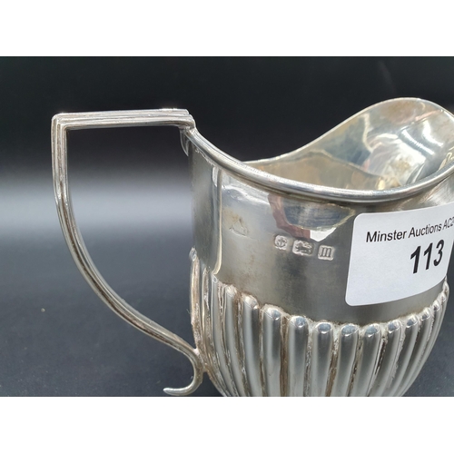 113 - A George V silver Jug of oval semi-fluted form, Birmingham 1911