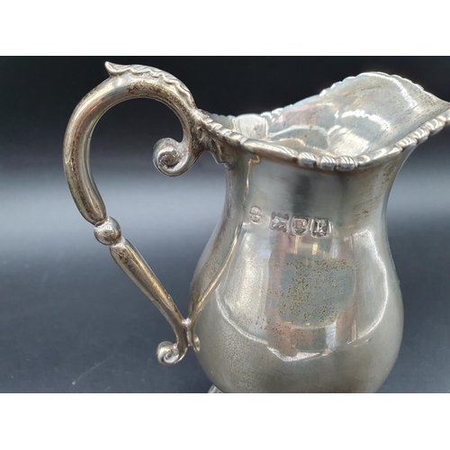 115 - An Edward VII silver baluster Cream Jug with leafage scroll handle, Birmingham 1909