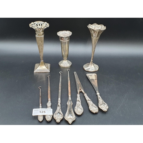 125 - Three silver Spill Vases, four silver handled Button Hooks, a Shoe Horn and pair of Glove Stretchers