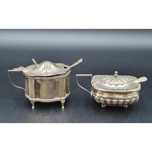 126 - An Edward VII silver oval Mustard Pot, Chester 1909, with blue glass liner and spoon, and a boat sha... 