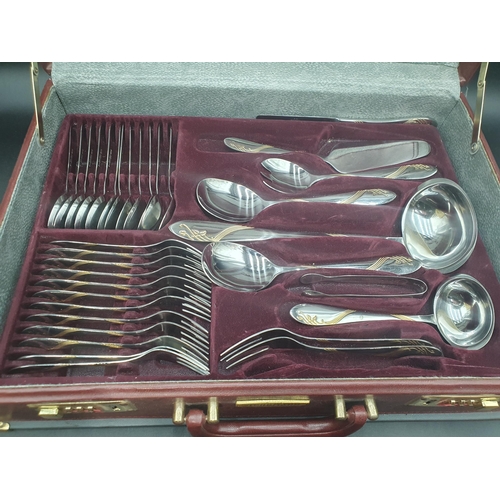 141 - A Canteen of Bergmann Solingen stainless steel Cutlery with gilt detail, in case (R2)