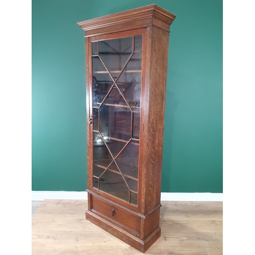 16 - An oak astragal glazed Bookcase with four adjustable shelves and fitted drawer to base, 6ft 4