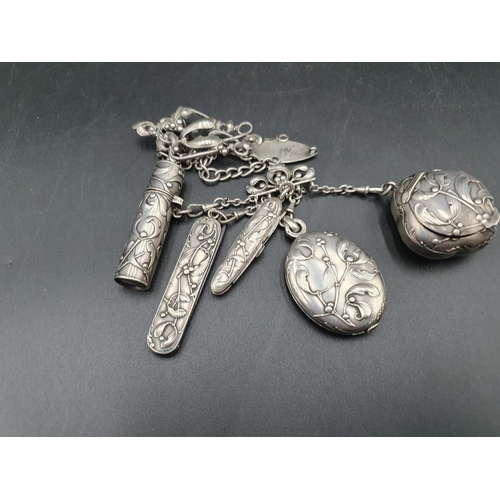 252 - A Continental Chatelaine with mistletoe decoration, includes mirror, compact, scent bottle, scissors... 