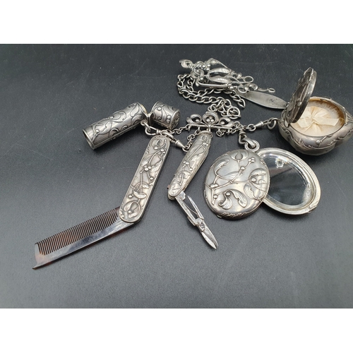 252 - A Continental Chatelaine with mistletoe decoration, includes mirror, compact, scent bottle, scissors... 