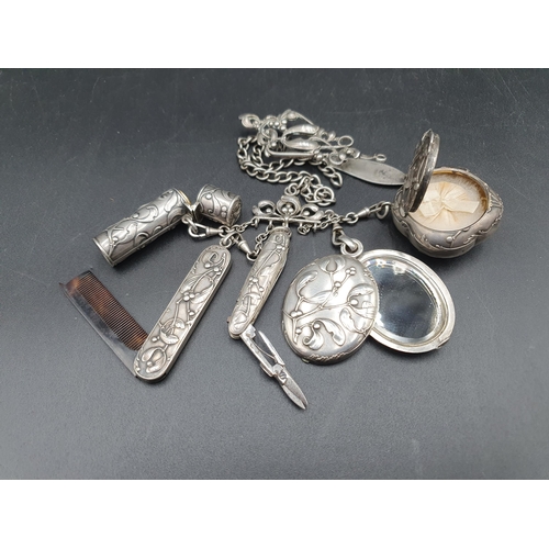 252 - A Continental Chatelaine with mistletoe decoration, includes mirror, compact, scent bottle, scissors... 