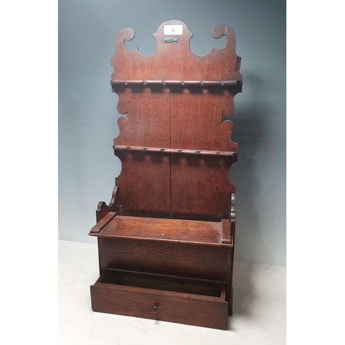 26 - An 18th Century oak Spoon Rack with shaped top and sides, compartment with sliding cover and drawer ... 