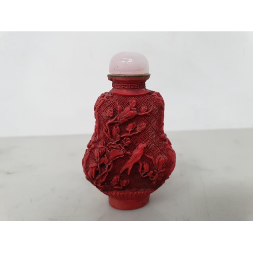 262 - A Chinese red cinnabar lacquered style Snuff Bottle decorated birds amongst flowering shrubs, pink c... 