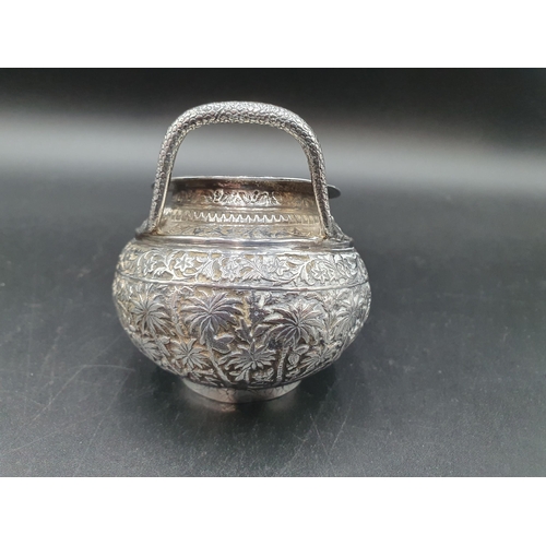 281 - An Indian silver Jug embossed and chased birds and animals in landscape frieze, serpent handle