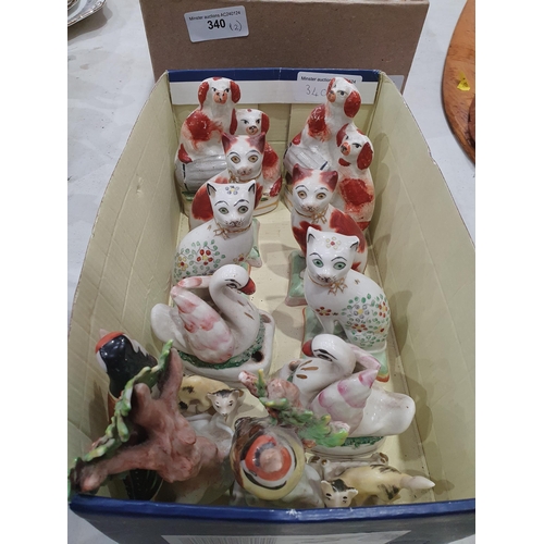 340 - A quantity of Staffordshire style Figures including, Seated Cats, Goldfinches, Seated Spaniels, Swan... 