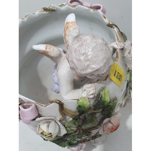 344 - A Lladro Dog, a continental floral encrusted Vase with winged Cherub looking out, on scrolled suppor... 