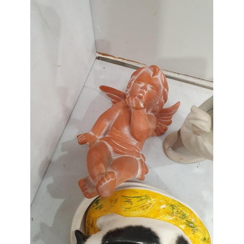 348 - A terra cotta Cherub, a Nao style Figure A/F, a Cow Tureen, a Tricia Duncan Paperweight, a set of Pl... 