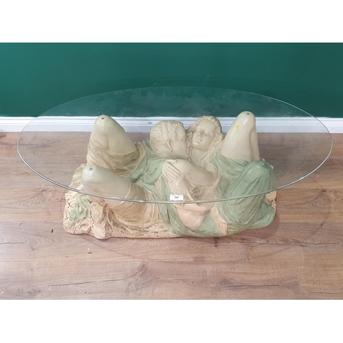 397 - A modern resin based Coffee Table in the form of a Couple Embracing with oval glass top, 4ft 2