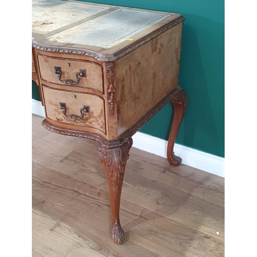 483 - A French style reproduction walnut veneered Serpentine fronted Desk, with inset tooled writing surfa... 