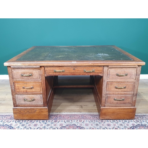 5 - An oak Partners Desk with inset tooled writing surface, both sides fitted single long drawer flanked... 