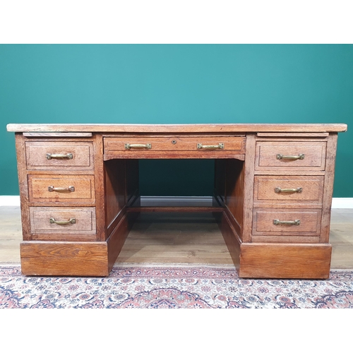 5 - An oak Partners Desk with inset tooled writing surface, both sides fitted single long drawer flanked... 