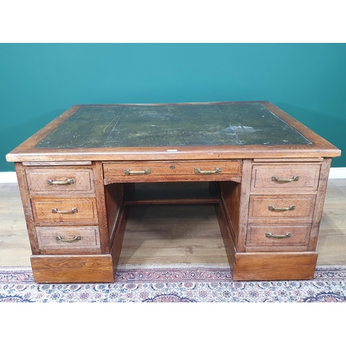 5 - An oak Partners Desk with inset tooled writing surface, both sides fitted single long drawer flanked... 