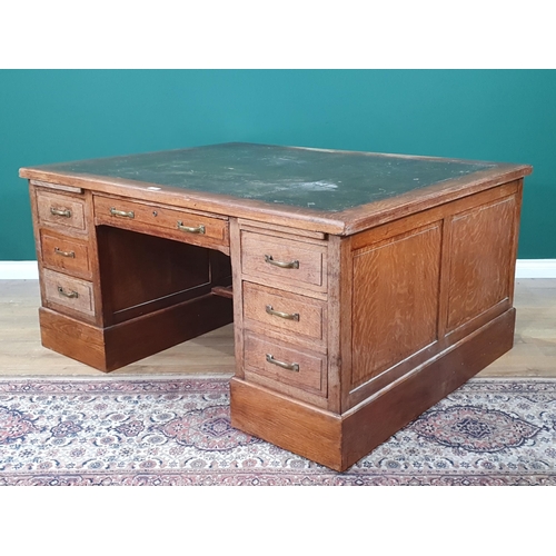 5 - An oak Partners Desk with inset tooled writing surface, both sides fitted single long drawer flanked... 