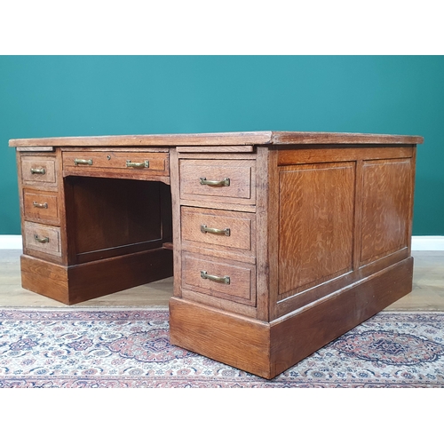 5 - An oak Partners Desk with inset tooled writing surface, both sides fitted single long drawer flanked... 