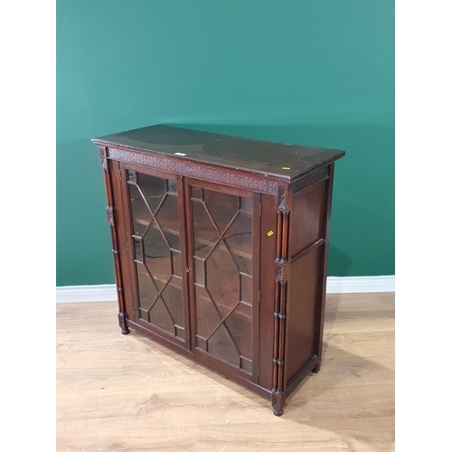 516 - A mahogany Display Cabinet, with carved frieze above pair of astragal glazed doors enclosing two fit... 