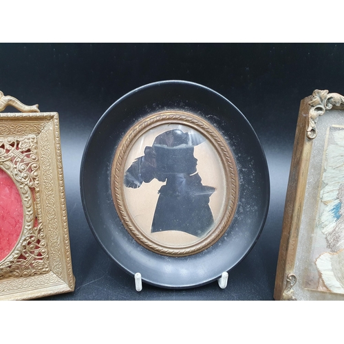 53 - A framed needlework Bust Portrait of young lady, oval Silhouette and a gilt metal Frame with ribbon ... 