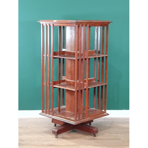 619 - An Edwardian mahogany revolving Bookcase, 2ft square, 51in high (R7)