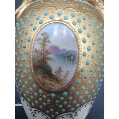 62 - A Coalport Cabinet Vase with oval cartouche painted Lake Leven, turquoise jewelled surround on gilt,... 