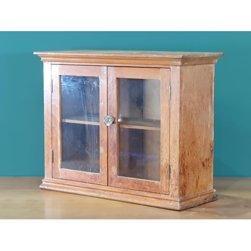 628 - A small beech glazed two door Cabinet, 2ft W x 18in H (R7)