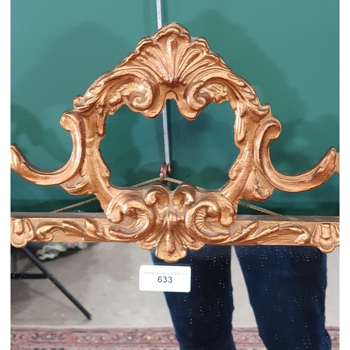 633 - A reproduction gilt scroll framed Wall Mirror, 32in W x 29in H (R7)