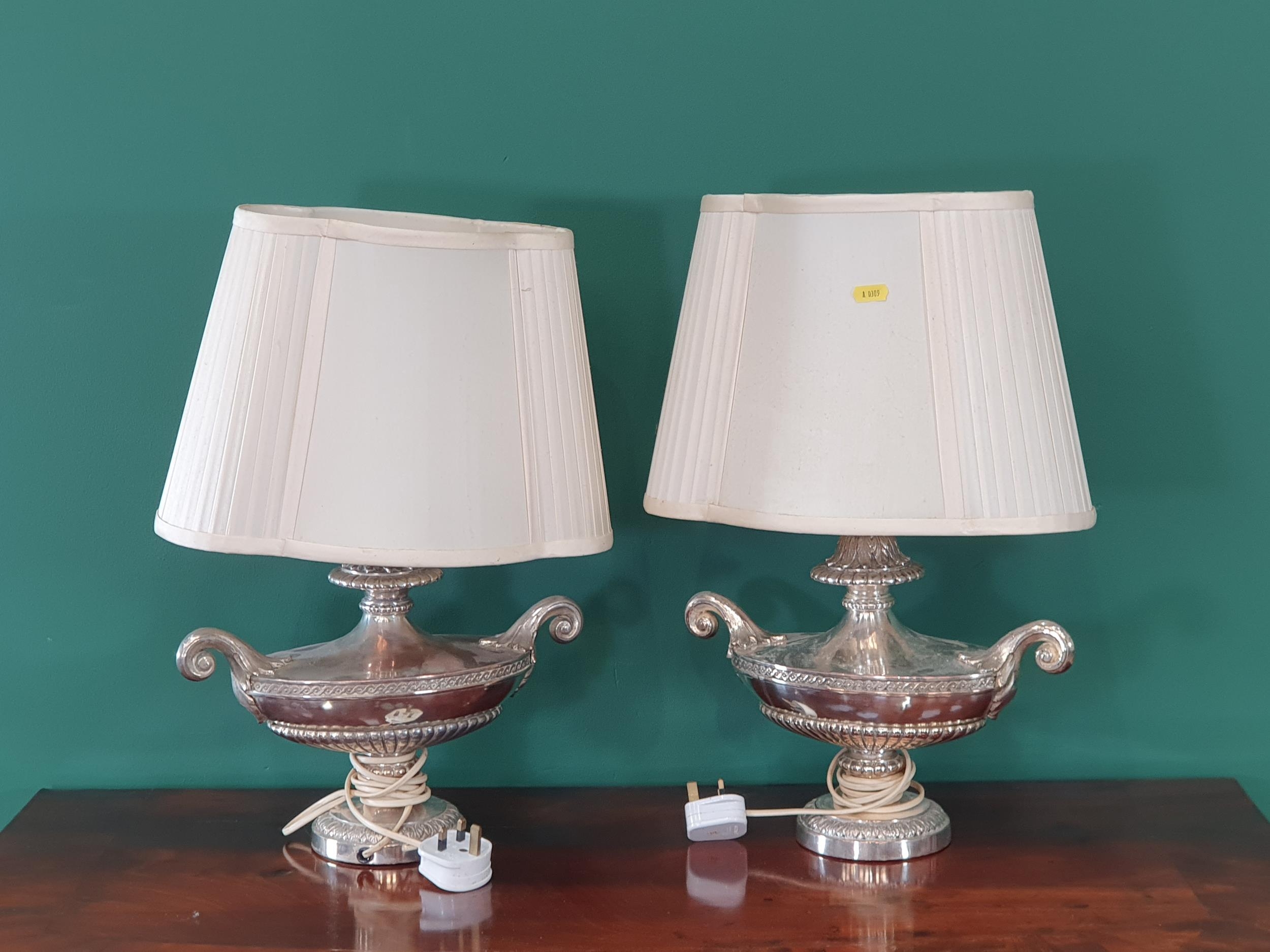 A pair of Silver plated Table Lamps in the form of Urns with scrolled ...