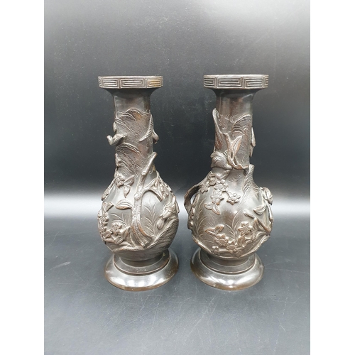 64 - A pair of Japanese bronze baluster Vases with bird and floral decoration in relief, 11 1/2in (R2)