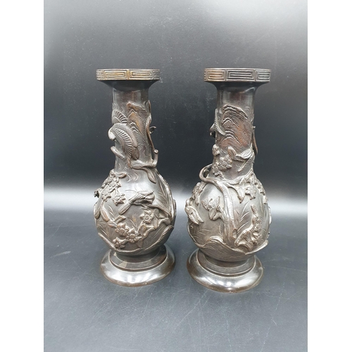 64 - A pair of Japanese bronze baluster Vases with bird and floral decoration in relief, 11 1/2in (R2)