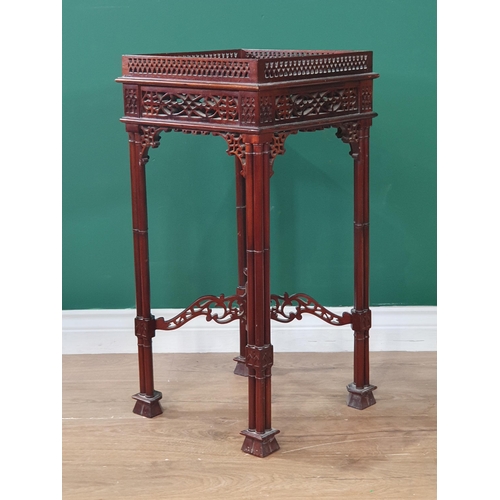 660 - A reproduction Chippendale style Jardiniere Stand with pierced gallery and frieze on four cluster co... 