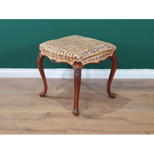 663 - A walnut framed Stool with floral striped upholstery on carved and shaped supports, 1ft 8