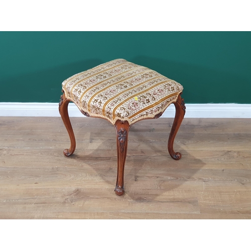 663 - A walnut framed Stool with floral striped upholstery on carved and shaped supports, 1ft 8