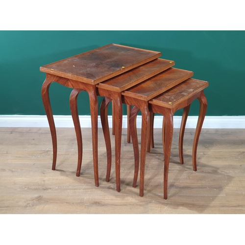 665 - A mahogany veneered Nest of four Tables on shaped supports, A/F, largest 2ft 4