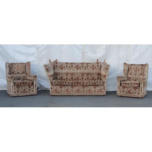 667 - A floral upholstered three seater Knowle Sofa and a pair of Armchairs. (R11).