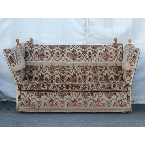 667 - A floral upholstered three seater Knowle Sofa and a pair of Armchairs. (R11).