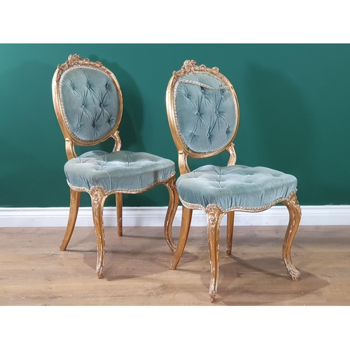 669 - A pair of gilt painted, blue button upholstered Bedroom Chairs with ribbon and flower decorations on... 