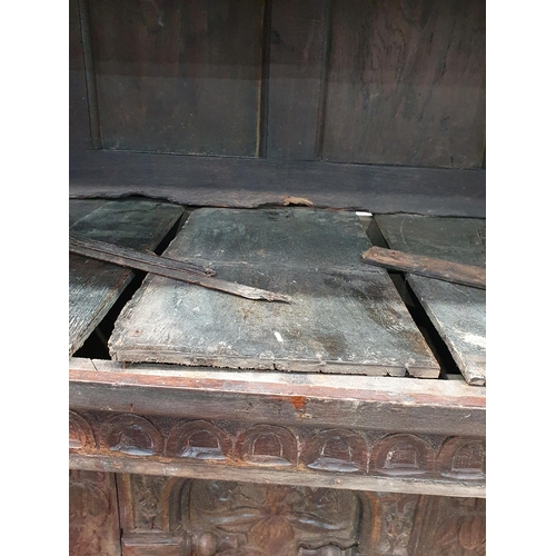 679 - An antique carved oak Tridarn with open bars to the sides of the upper section, fitted a pair of cup... 