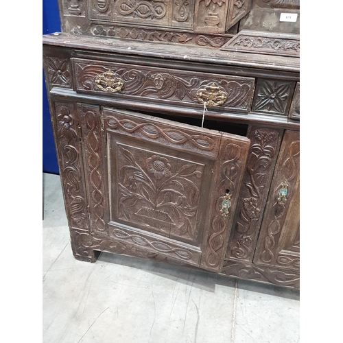 679 - An antique carved oak Tridarn with open bars to the sides of the upper section, fitted a pair of cup... 