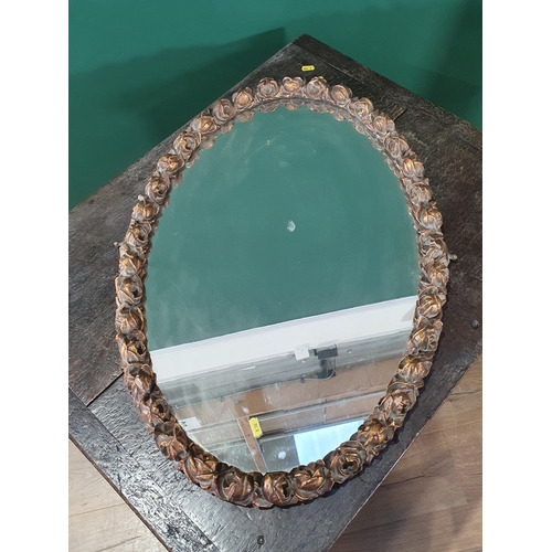 683 - An oval gilt-framed Dressing Table Mirror, moulded with flower heads, 30in x 20in (R7)