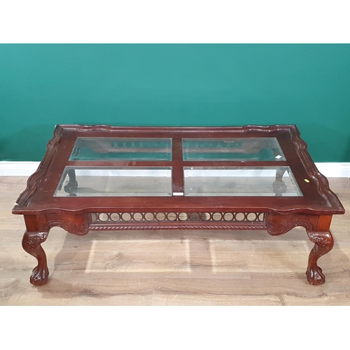 688 - A reproduction mahogany glass topped Coffee Table on claw and ball supports, A/F, 17