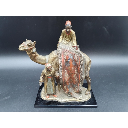 69 - An Austrian, Bergmann style cold painted Table Lighter in the form of a Carpet Seller with camel and... 